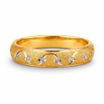 A 21K gold band ring with a matte textured finish and delicate silver swirls, no gemstones