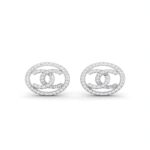 Sparkling silver double-C design stud earrings displayed on a jewellery stand