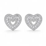 Heart-shaped sparkling stone stud earrings worn on ear